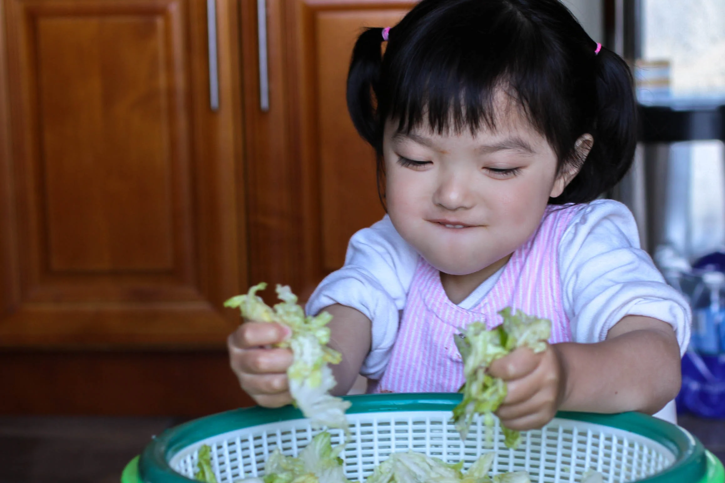 Allyson rings out the salty napa cabbage.
