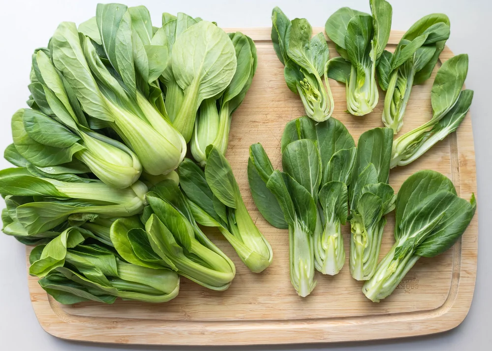 Raw bok choy on cutting board