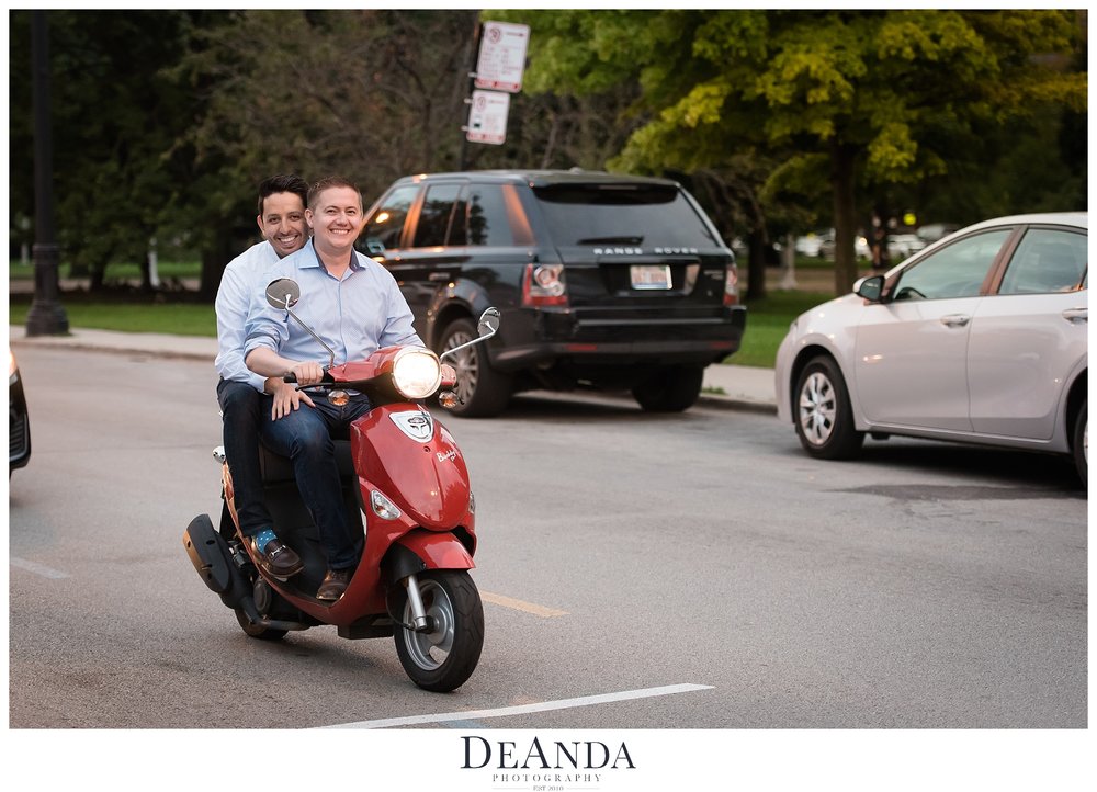 same sex couple on scooter