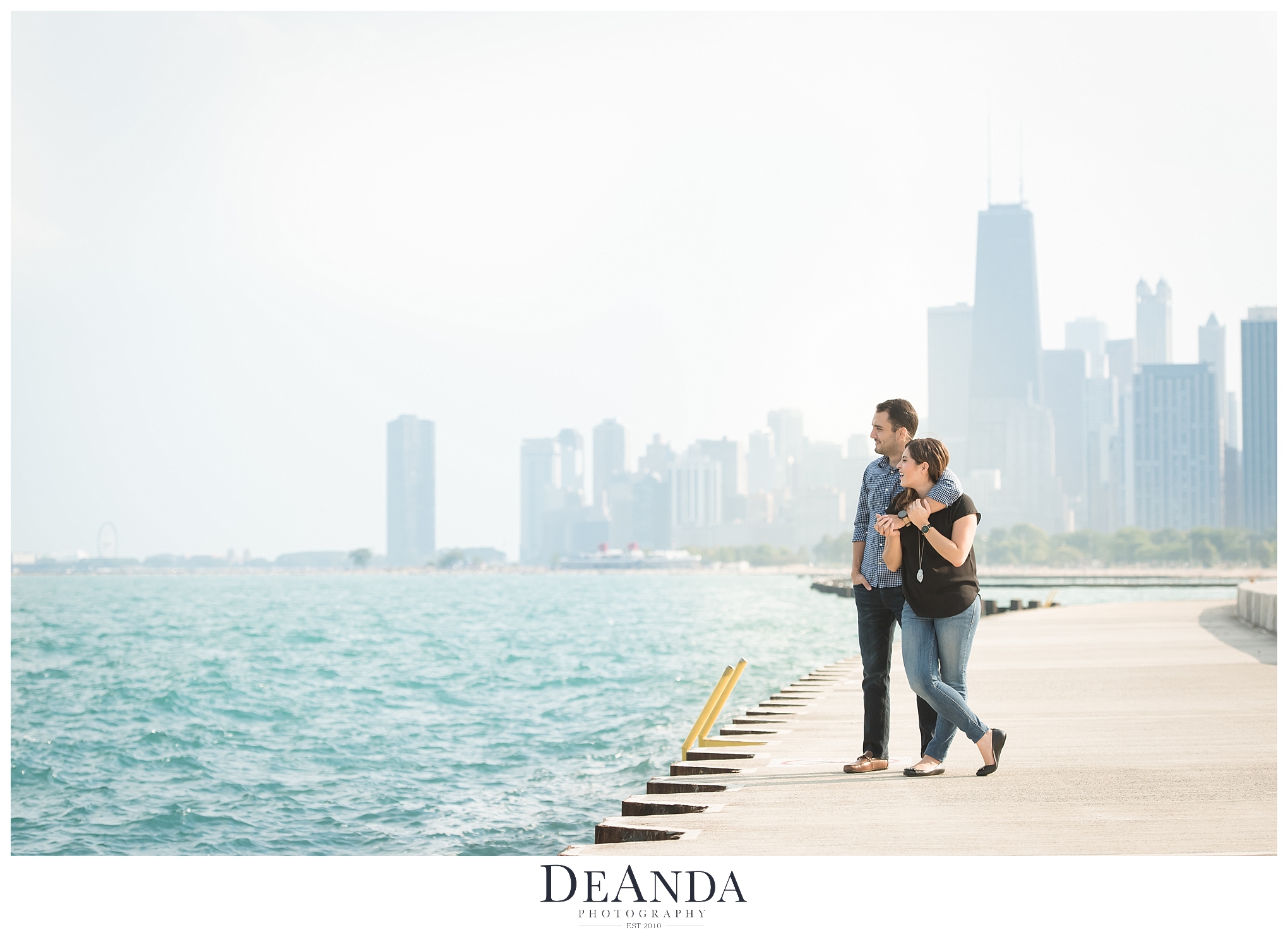 couple on lake front with skyline in the background