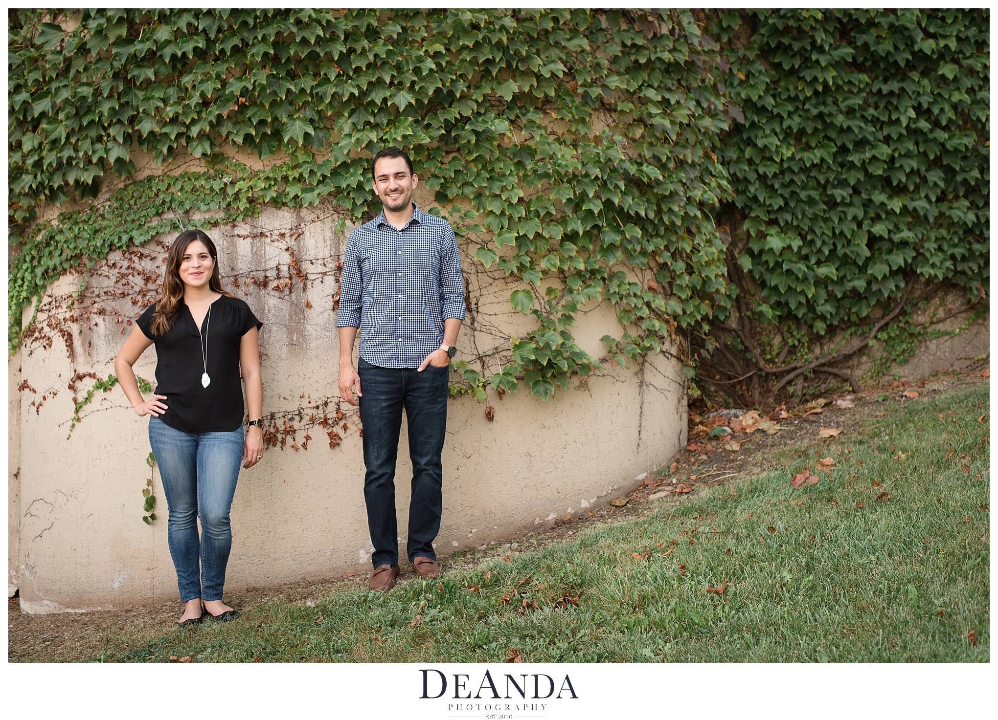 couple in front of ivy wall