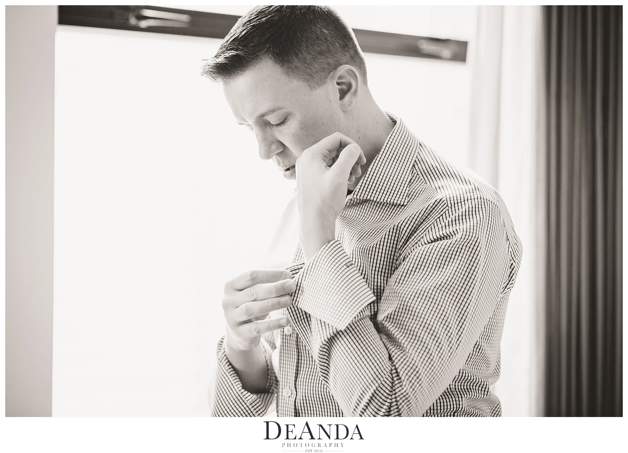 buttoning cufflinks getting ready at the Gwen