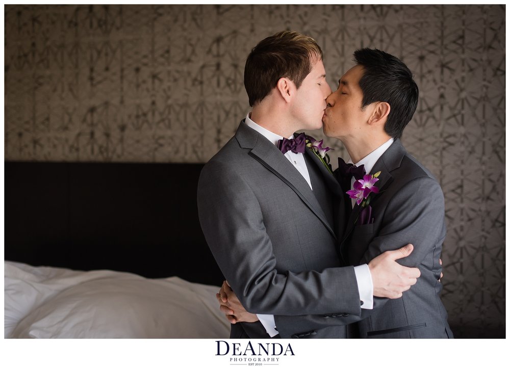 two grooms kissing each other