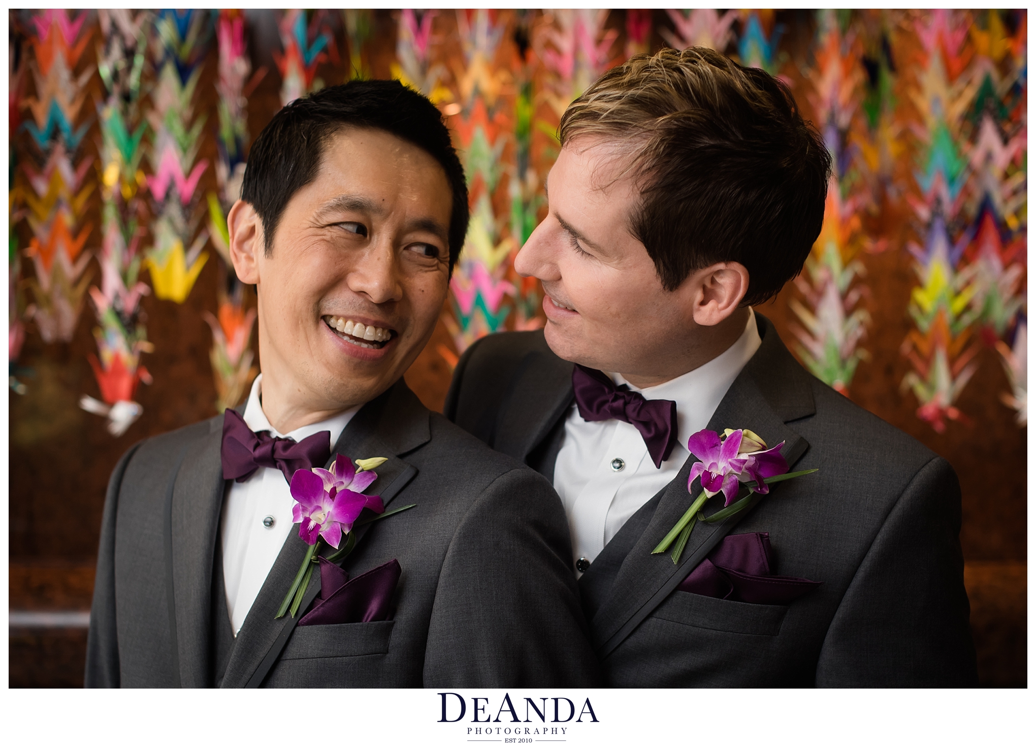two groom in front of paper cranes