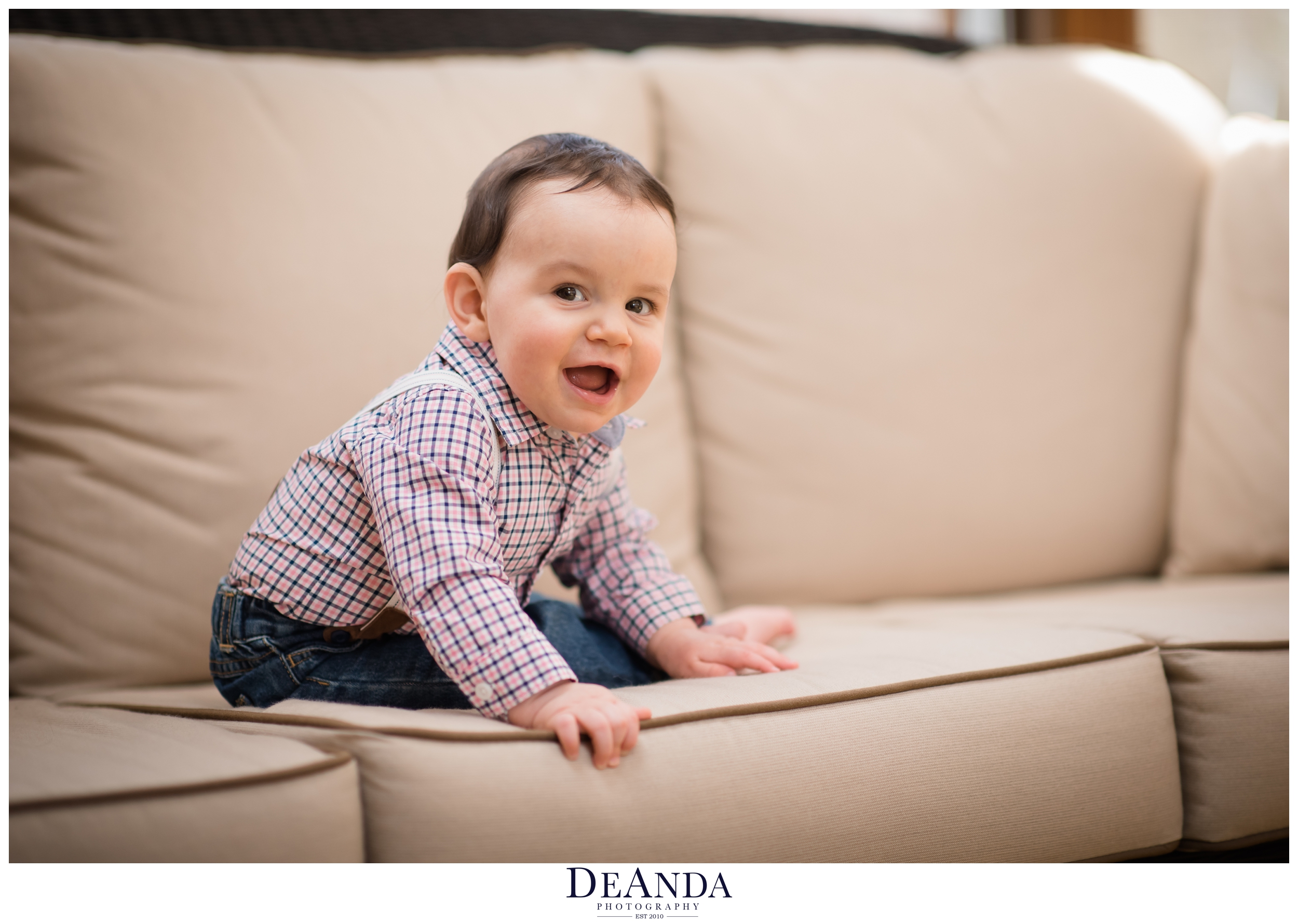 smiling 7 month old baby on couch
