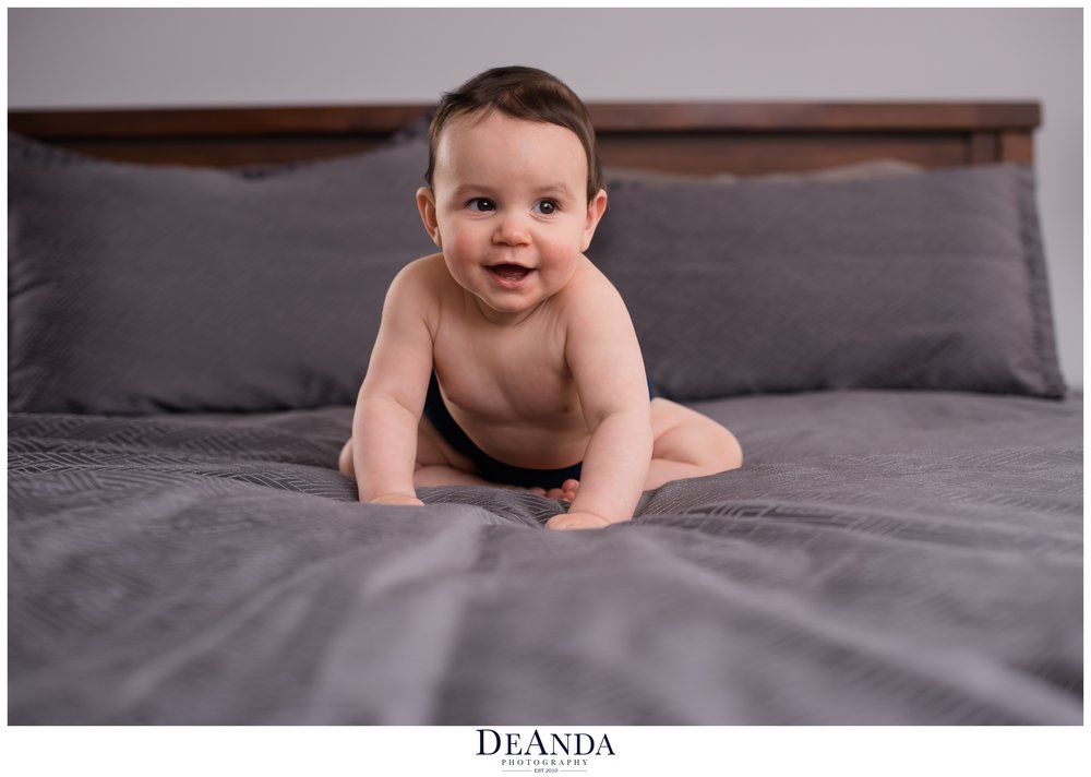 baby crawling on bed