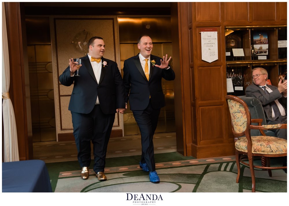 two grooms entering their reception in chicago