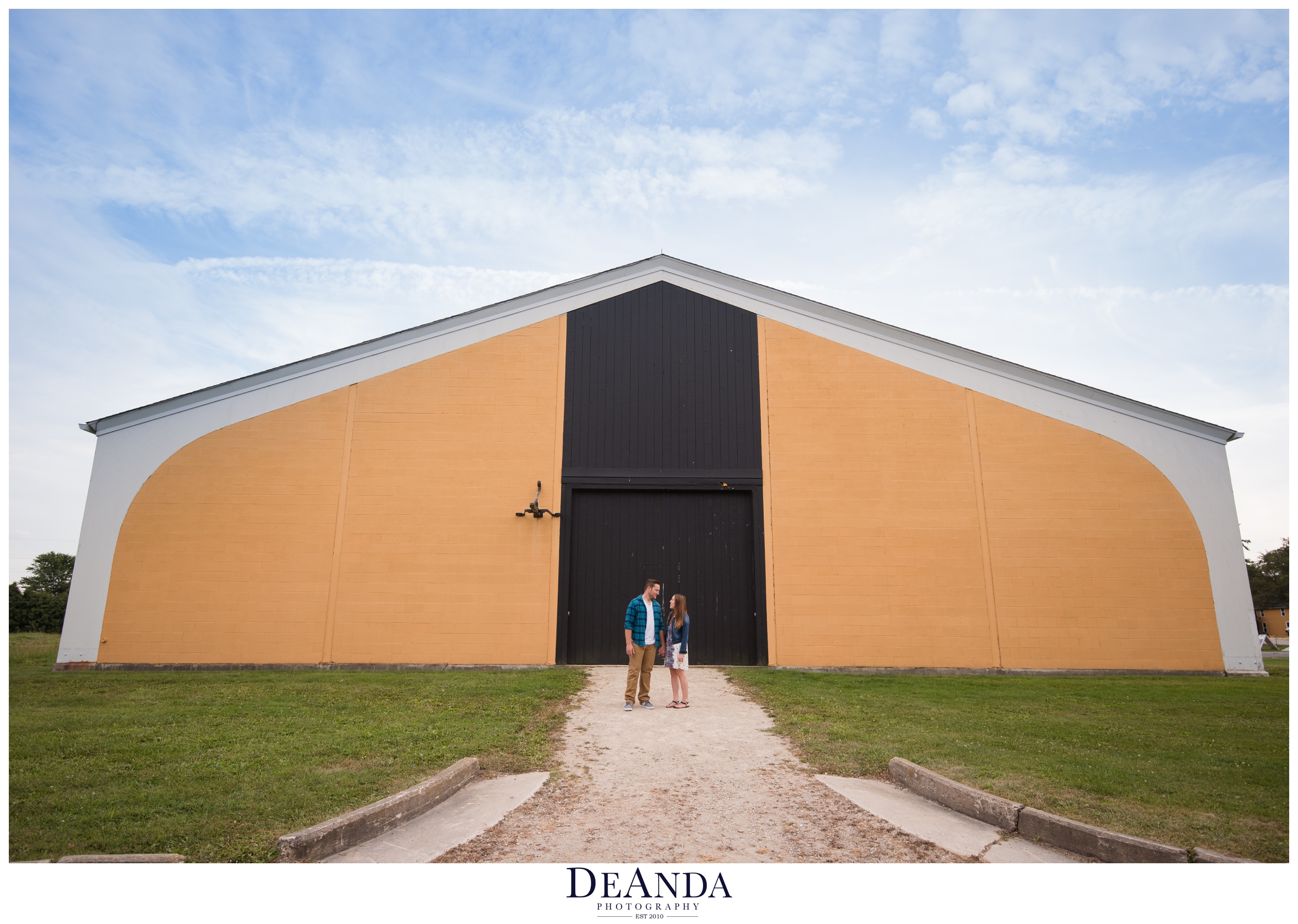 st.james farm engagement photos in front of indoor arena
