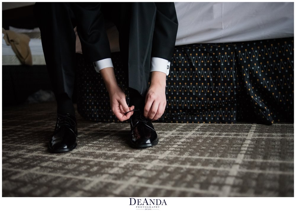 groom getting ready at Pheasant Run Resort in St.Charles Illinois