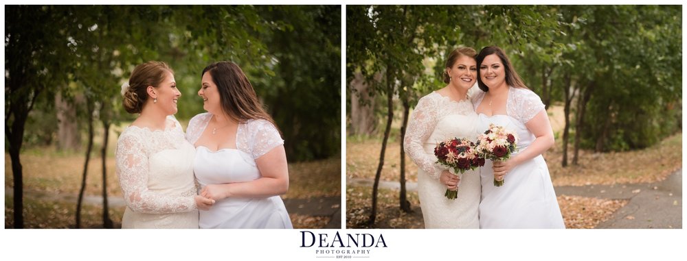 beautiful brides portrait of same sex couple in front of green trees