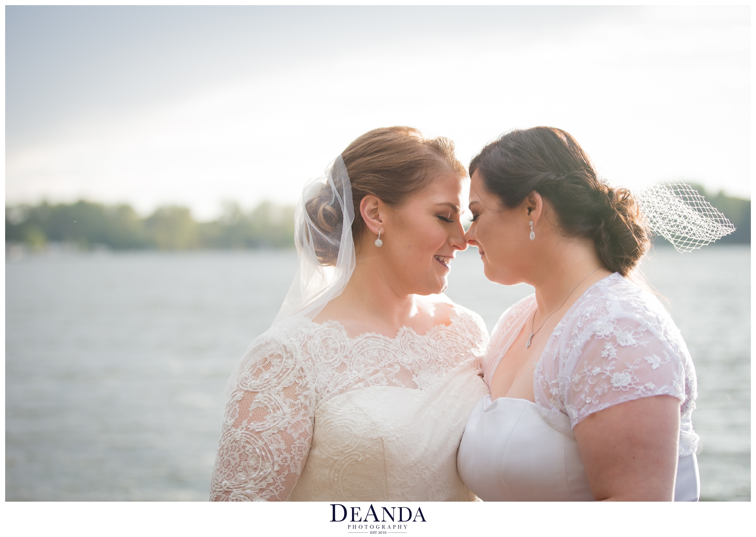 beautiful brides portrait of same sex couple on a lake pier over the water