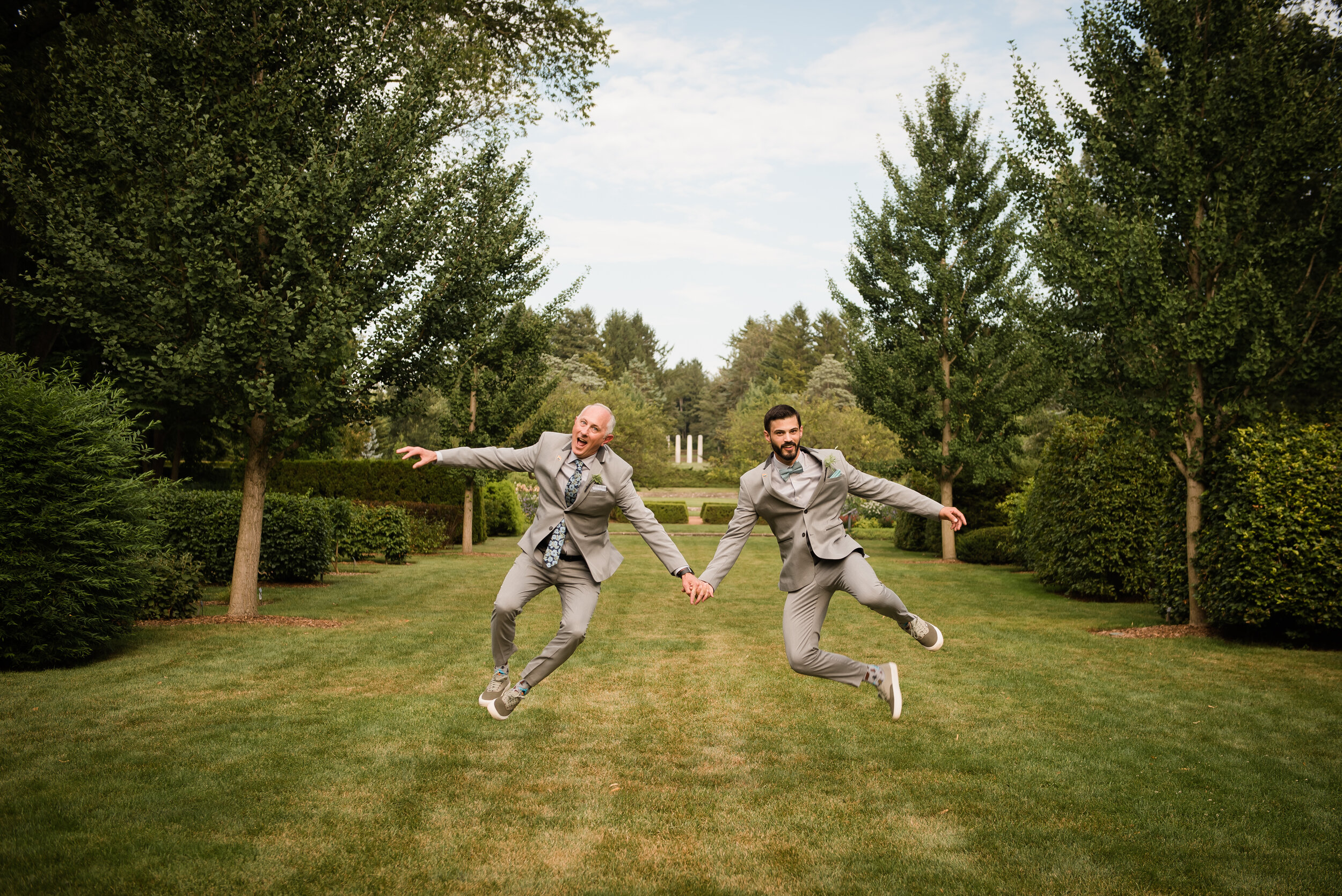 Morton Arboretum Wedding Gay Couple Jumping Into Air Clicking heels 
