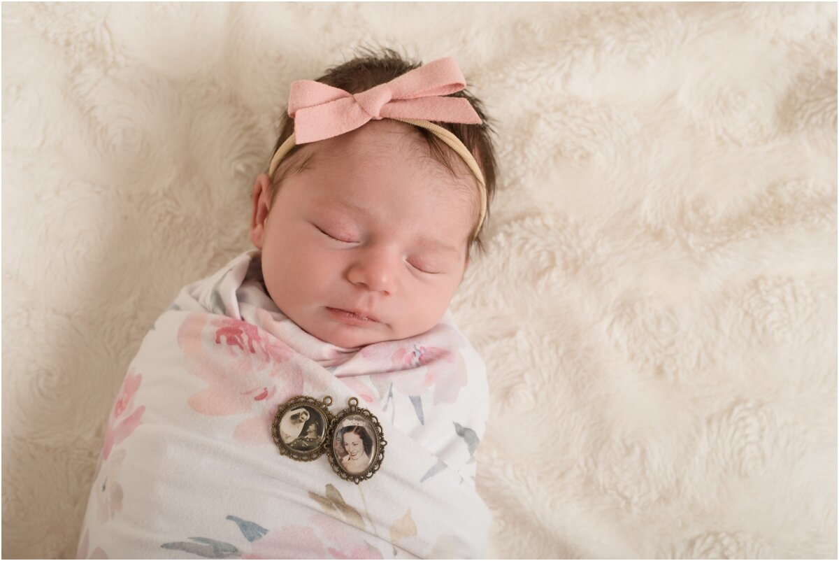 newborn with locket on her chest