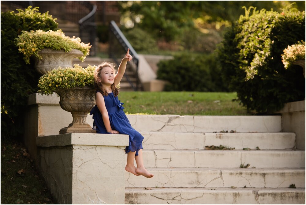 Little girl on mansion grounds