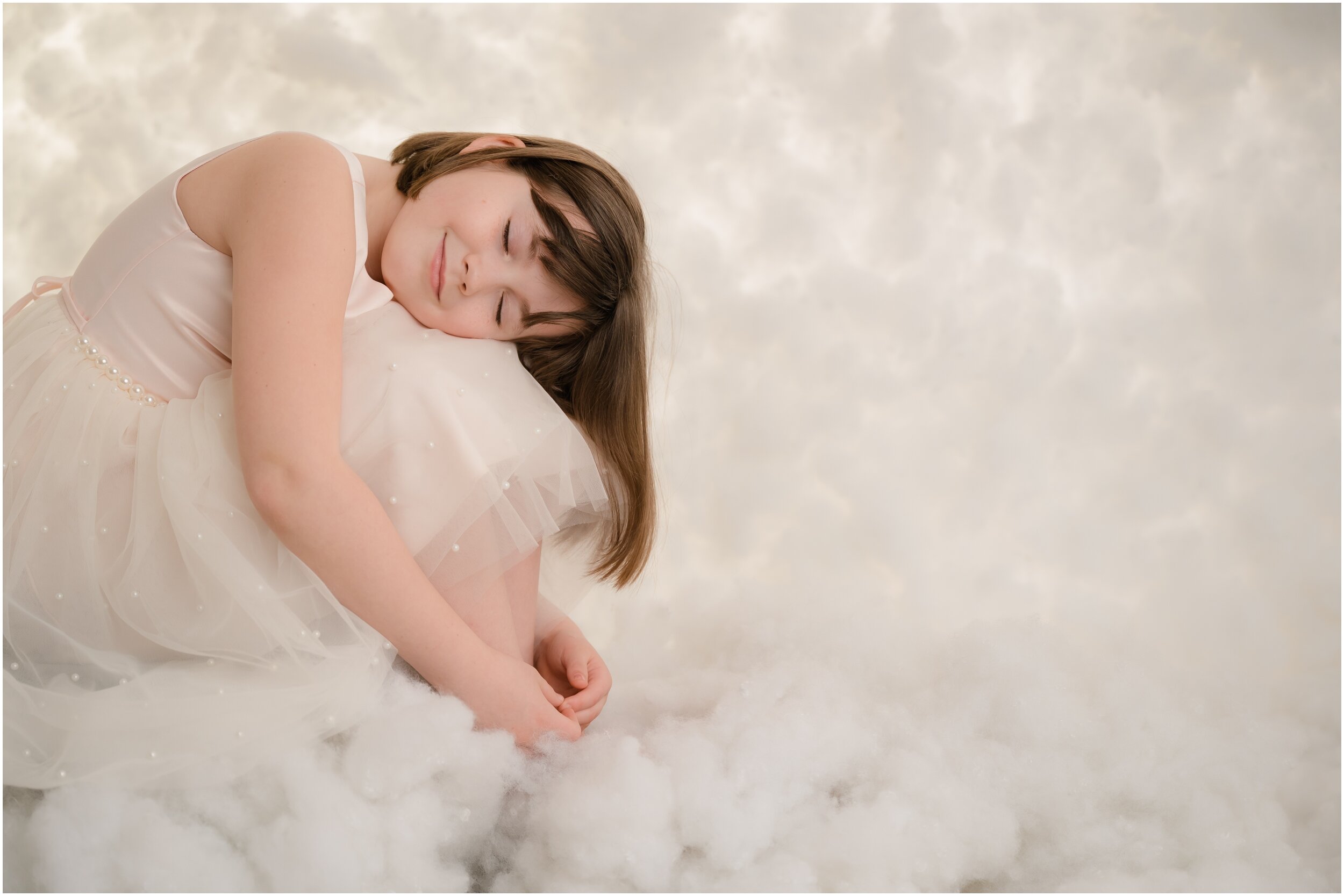 little girl sleeping in the clouds
