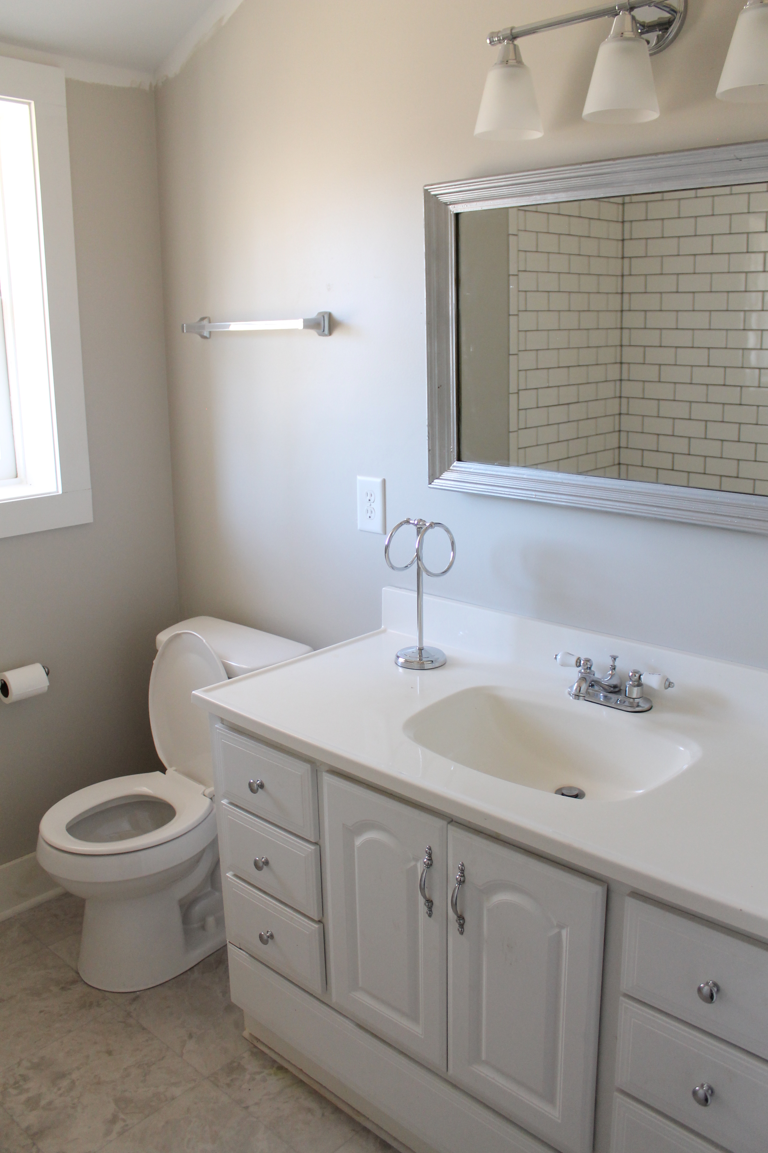 Elizabeth Burns Design | Bathroom Renovation on a Budget - diy subway tile, craigslist vanity, SW Agreeable Gray, vinyl flooring