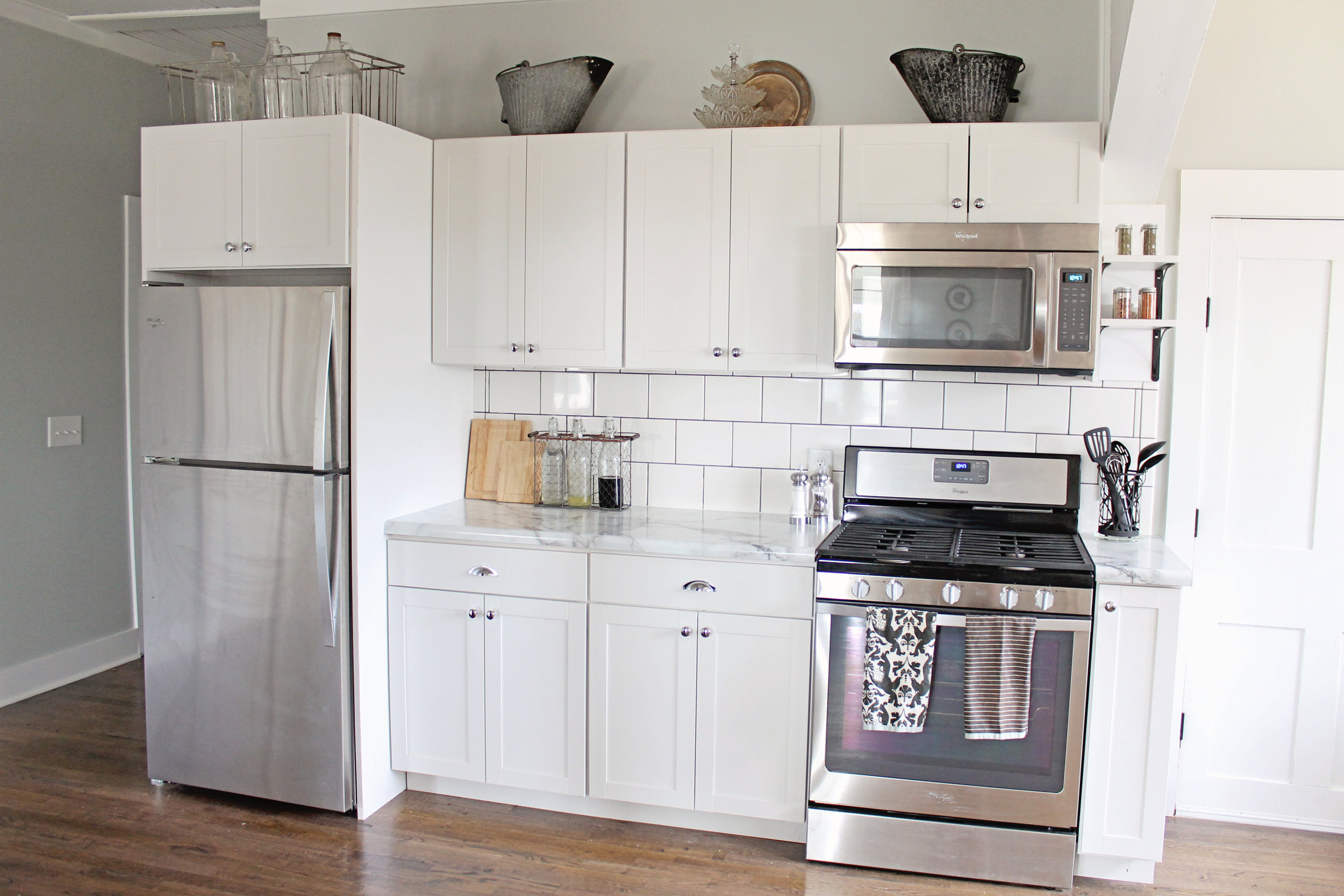 Elizabeth Burns Design | Budget Farmhouse Kitchen Renovation Fixer Upper - white shaker cabinets, formica marble laminate counter, subway tile, sherwin williams silver strand