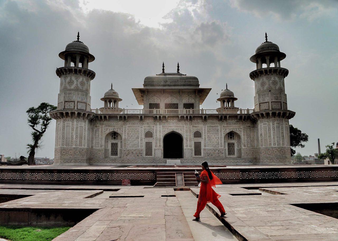 Girl in Red passing through the Tomb of I'timād-ud-Daulah