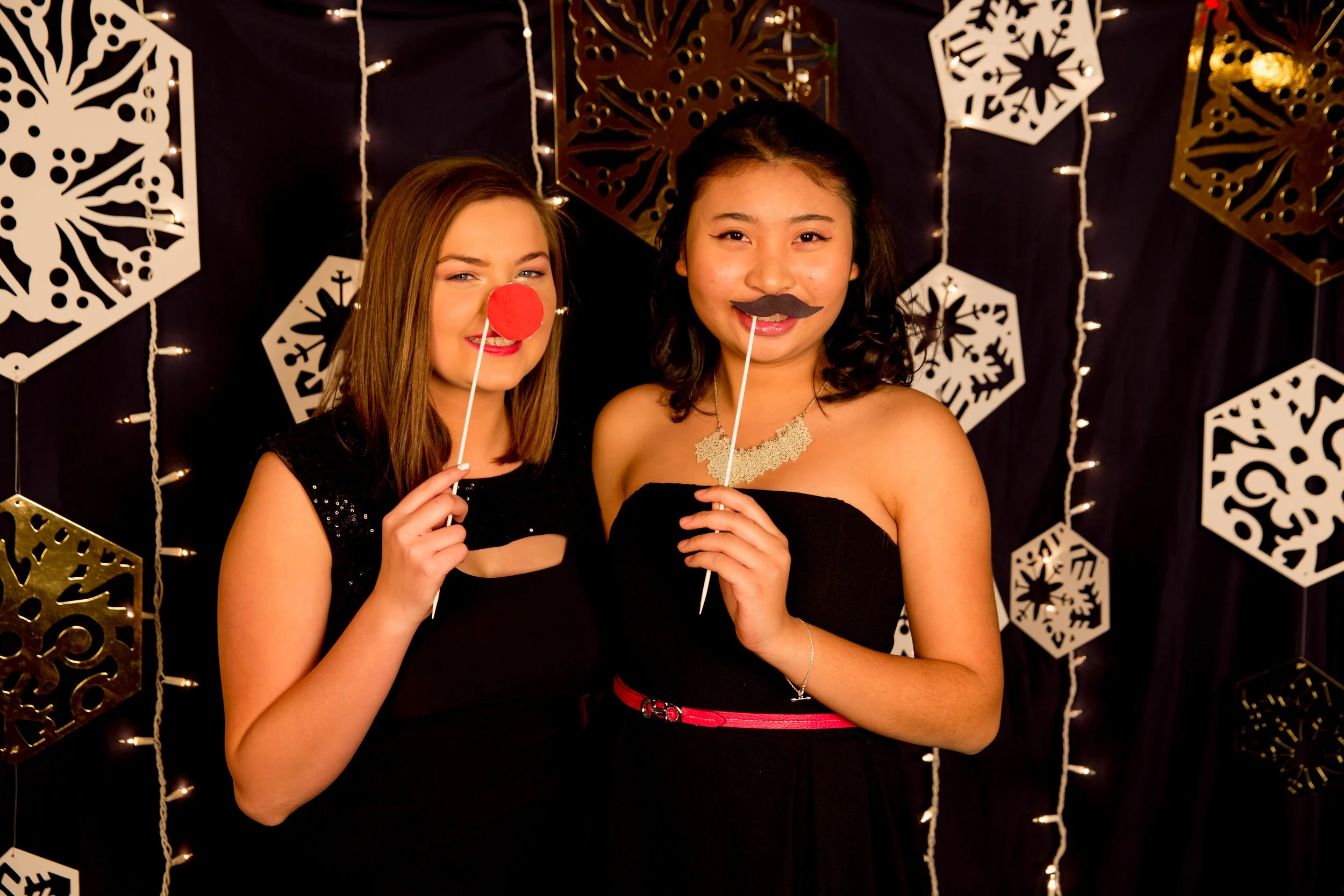Nhi Nguyen and Ashley Jarvi pose at Hillcrest's Christmas banquet photobooth
