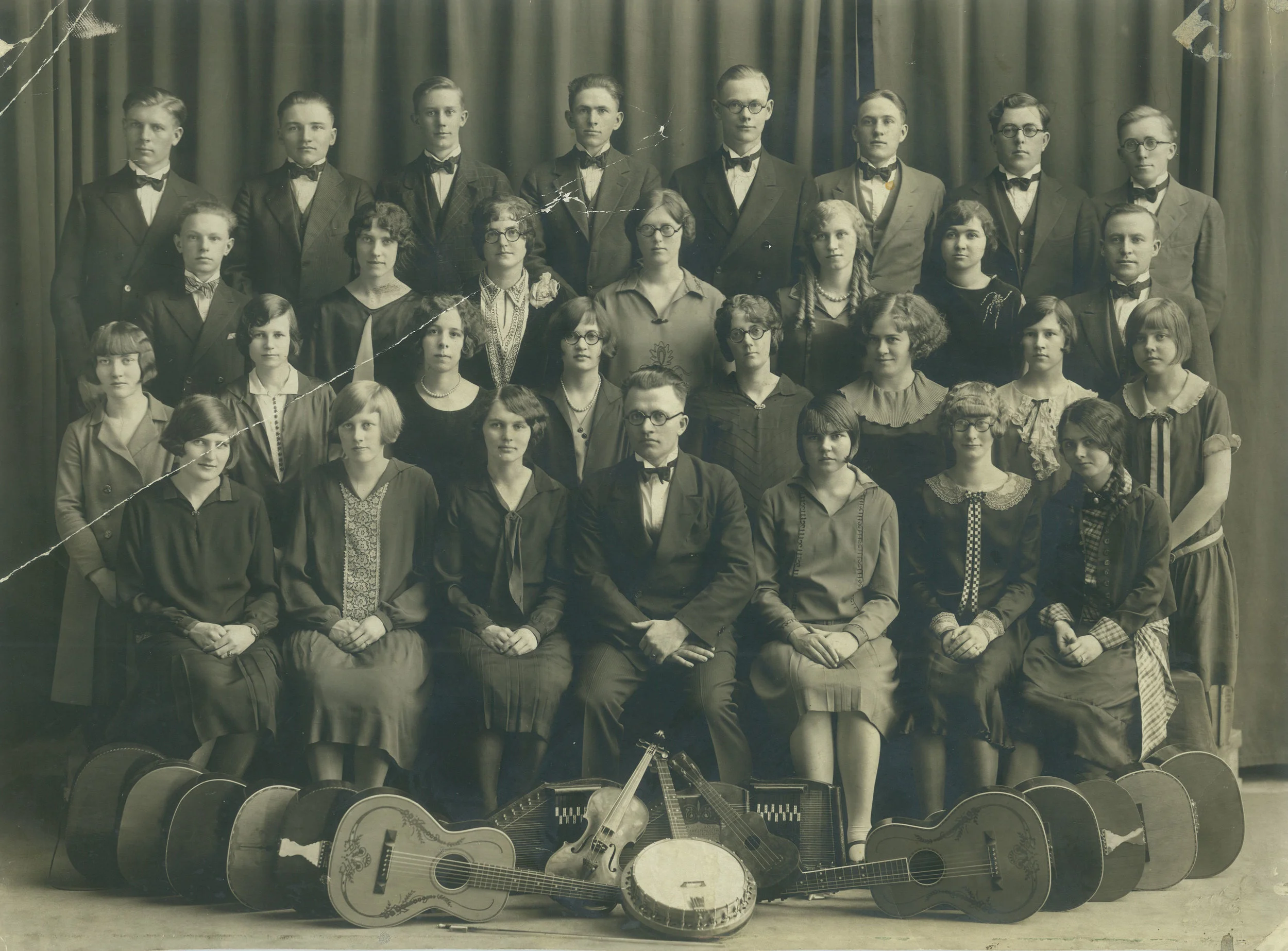 The 1925-26 string band was a highlight for Minnie, standing third from the right in the second row. Her proficiency on the harp opened doors for her to tour with the group throughout Minnesota and North Dakota.