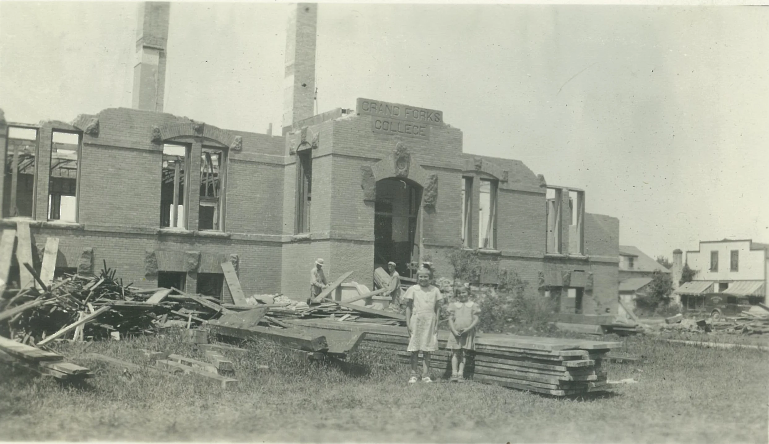 Children gathered to watch the historic Hillcrest building demolition after the Board of Trustees moved to tear the building down and sell the lumber and materials in an effort to raise money during the depression.