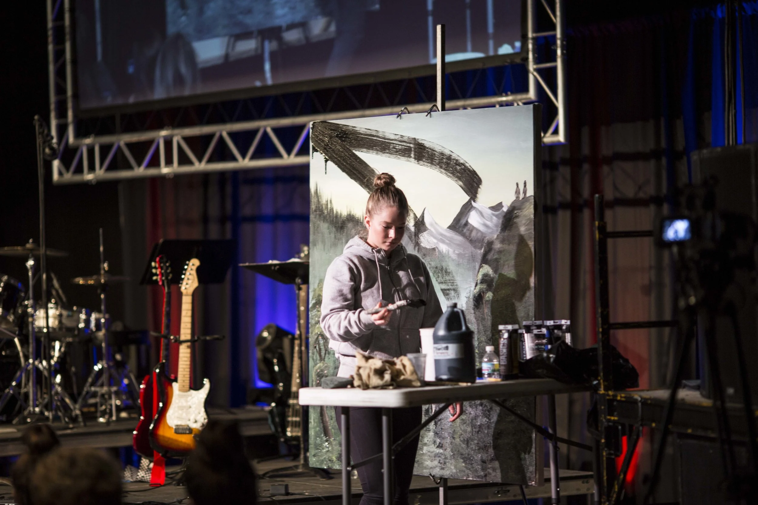 Leonora Tuvin paints over Sylvia's painting, an artistic depiction of the fall, during day two of Prayer Day