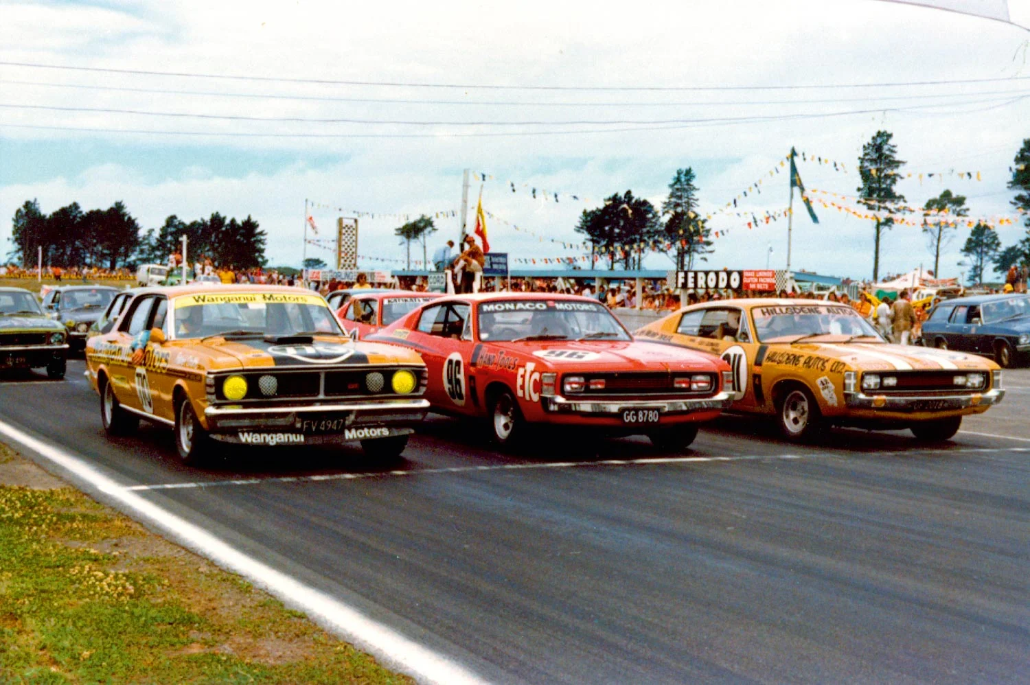 Production racing muscle cars. Patrick Smith in the Falcon GT-HO Phase III lines up next to the E49 Chargers of Rodger Anderson and Leo Leonard
