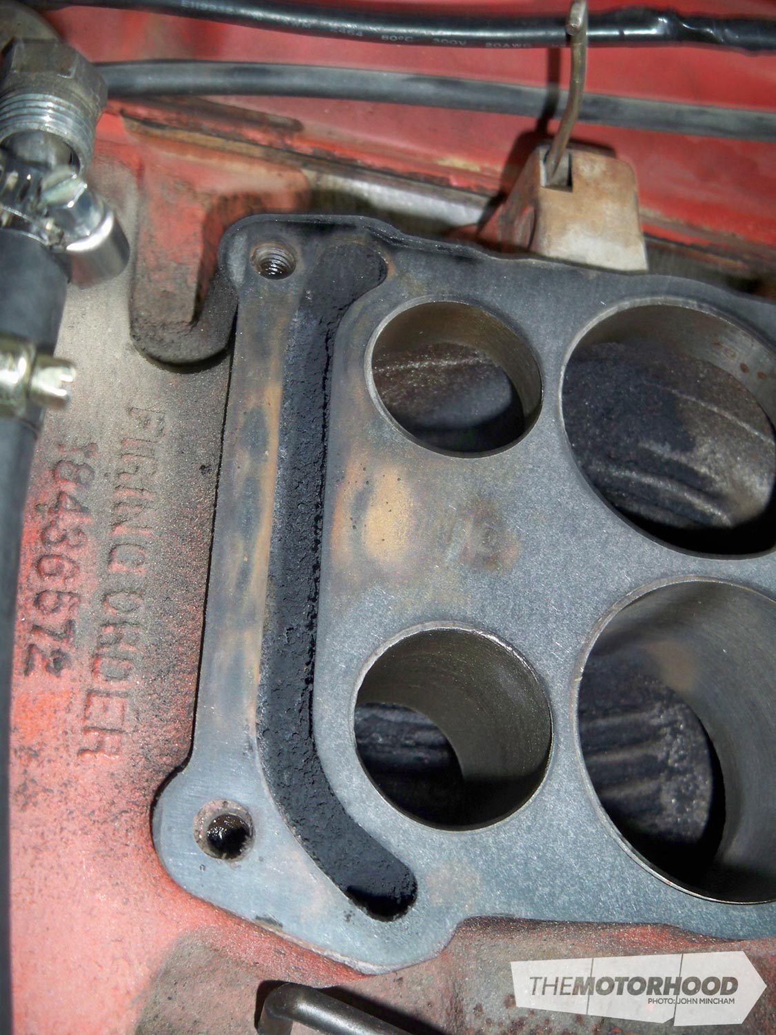 The discolouration shows the effect of the carb being warped. The soot you see in the cross-over pipe in indicative of what the rest of the carb looked like