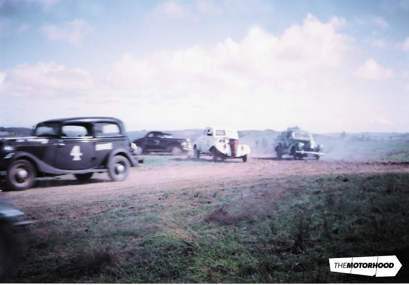 Kicking up the dust at Worrall's Farm. Unknown sedan (a '34 V8) leads what could be Rob Campbell's white '37 coupe, with Alan Smail's A40 ute taking the outside line; Kumeu 1966 (Photo: Peter Lodge collection)