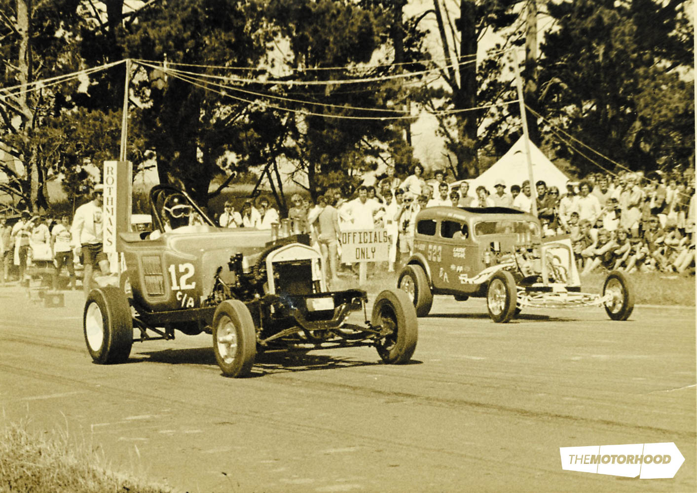 Kerrs Road, Wiri, South Auckland; Owen Campbell has the jump in his GMC six–powered T-bucket ('Junior Jimmy') over Dave McDougall's 292ci Ford V8–powered Austin (Photo: Peter Lodge collection)