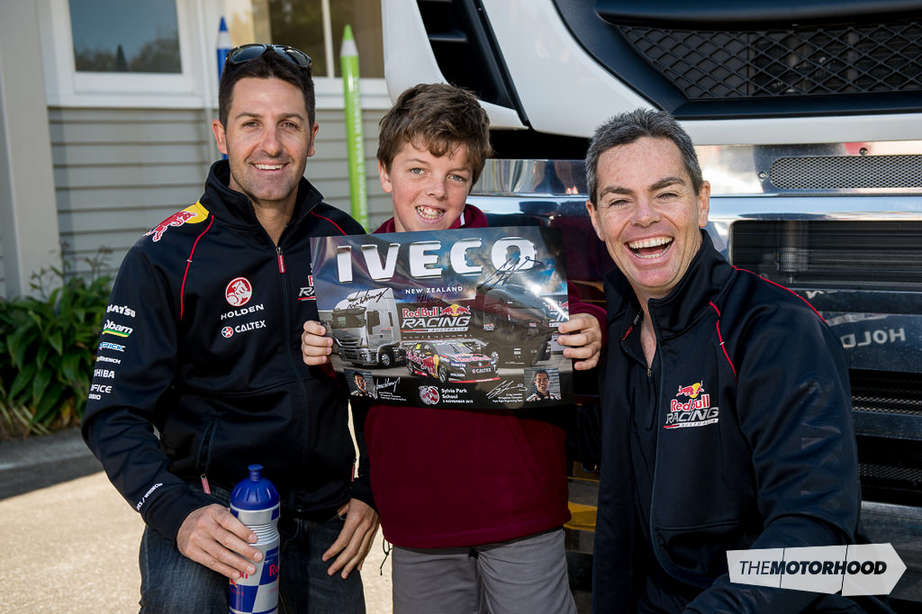 Six-time V8 Supercar winner Jamie Whincup (left) and teammate Craig Lowndes flank Sylvia Park primary student Cole Turner