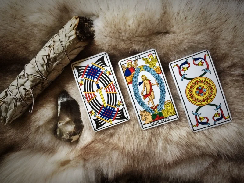 Nine of Swords, The World, and Ace of Pentacles.