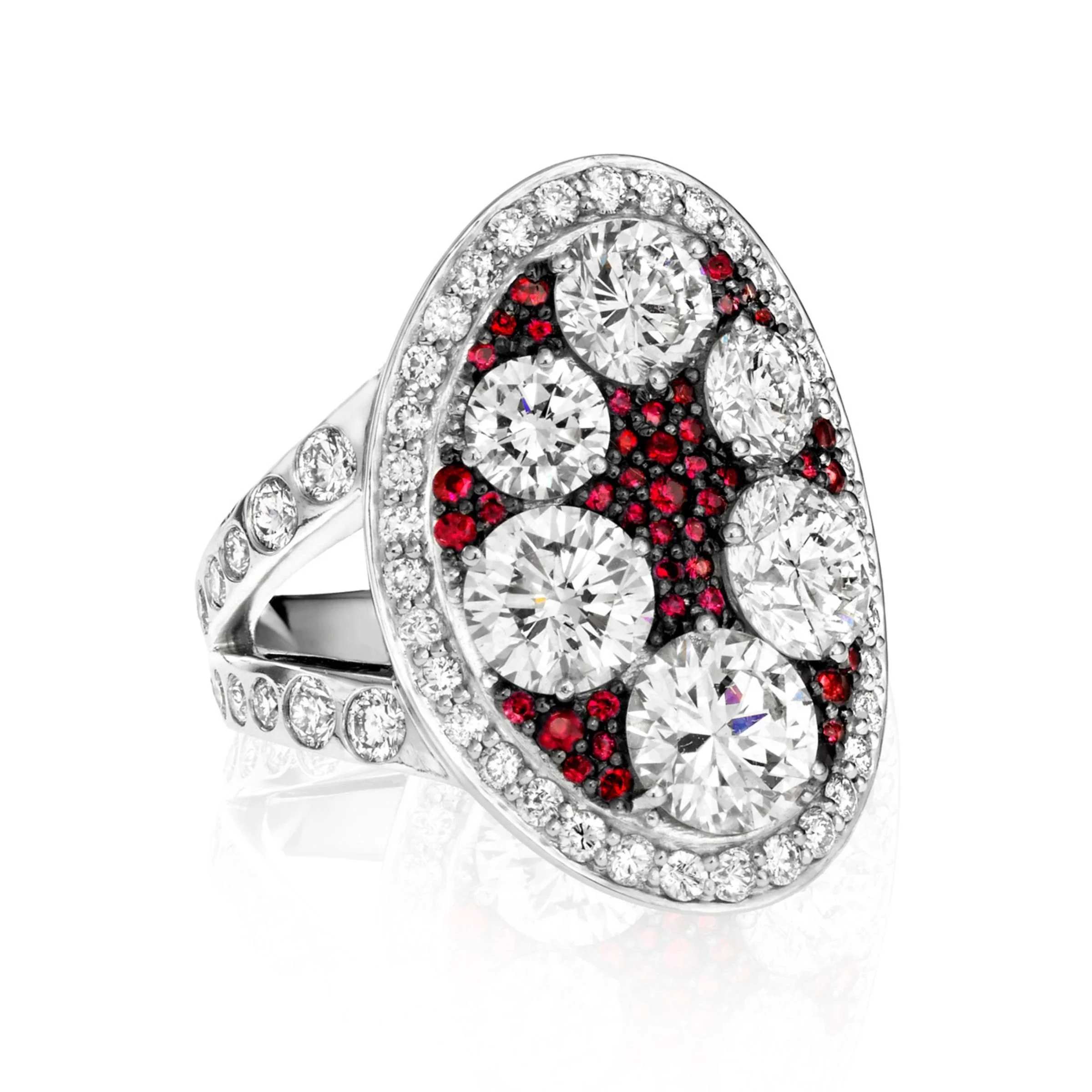Heirloom Redesign platinum cocktail ring featuring. large oval face set with five round diamonds, pave border, and micro pave red rubies. Flush set diamonds on platinum