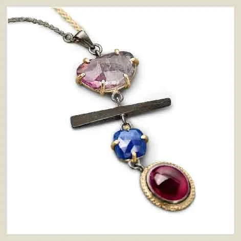 Pendant detail made by EatMetal showing pink tourmaline and sapphire.