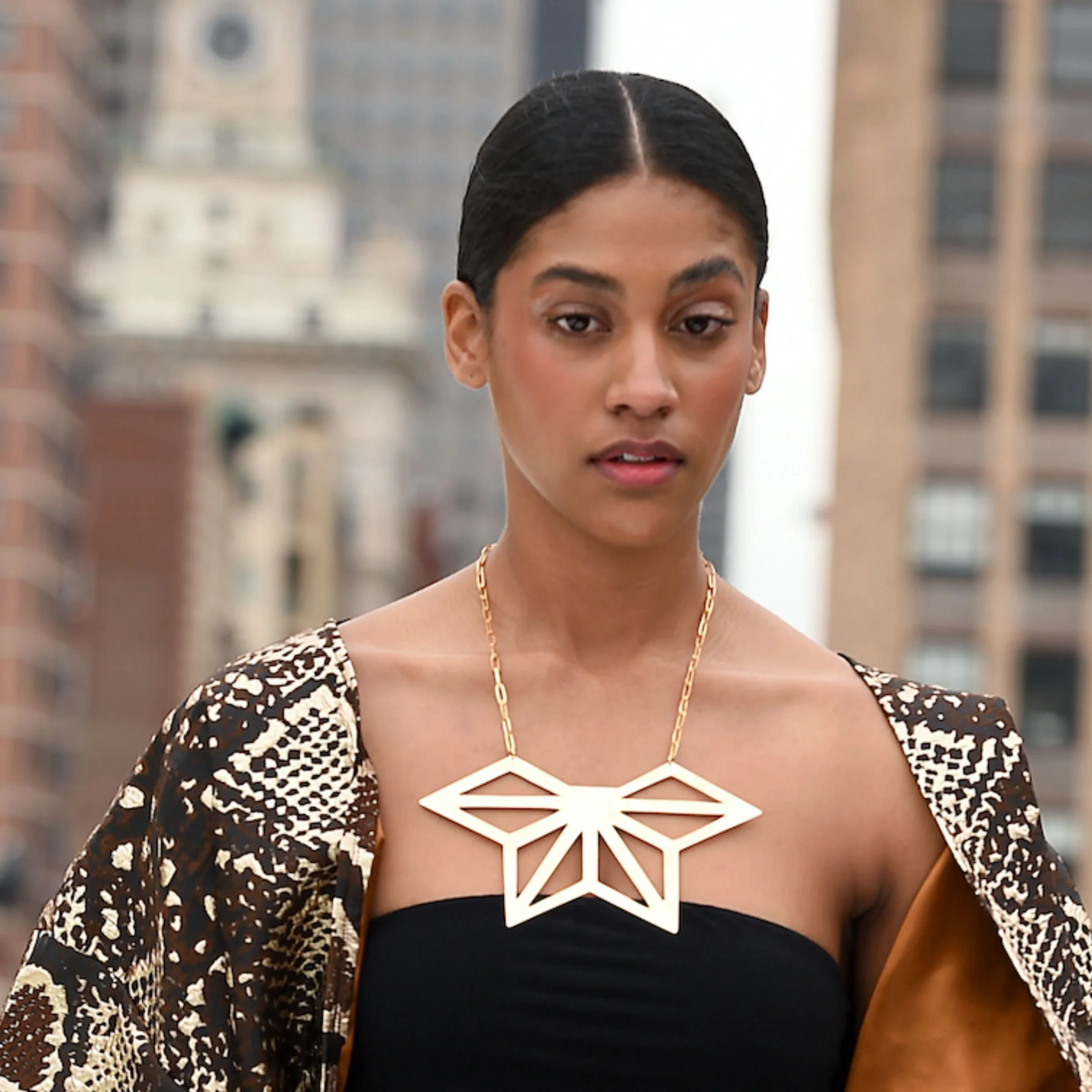 Model wearing the EatMetal architectural Hemi-Asanoha geometric gold statement necklace with a handcrafted paperclip chain.
