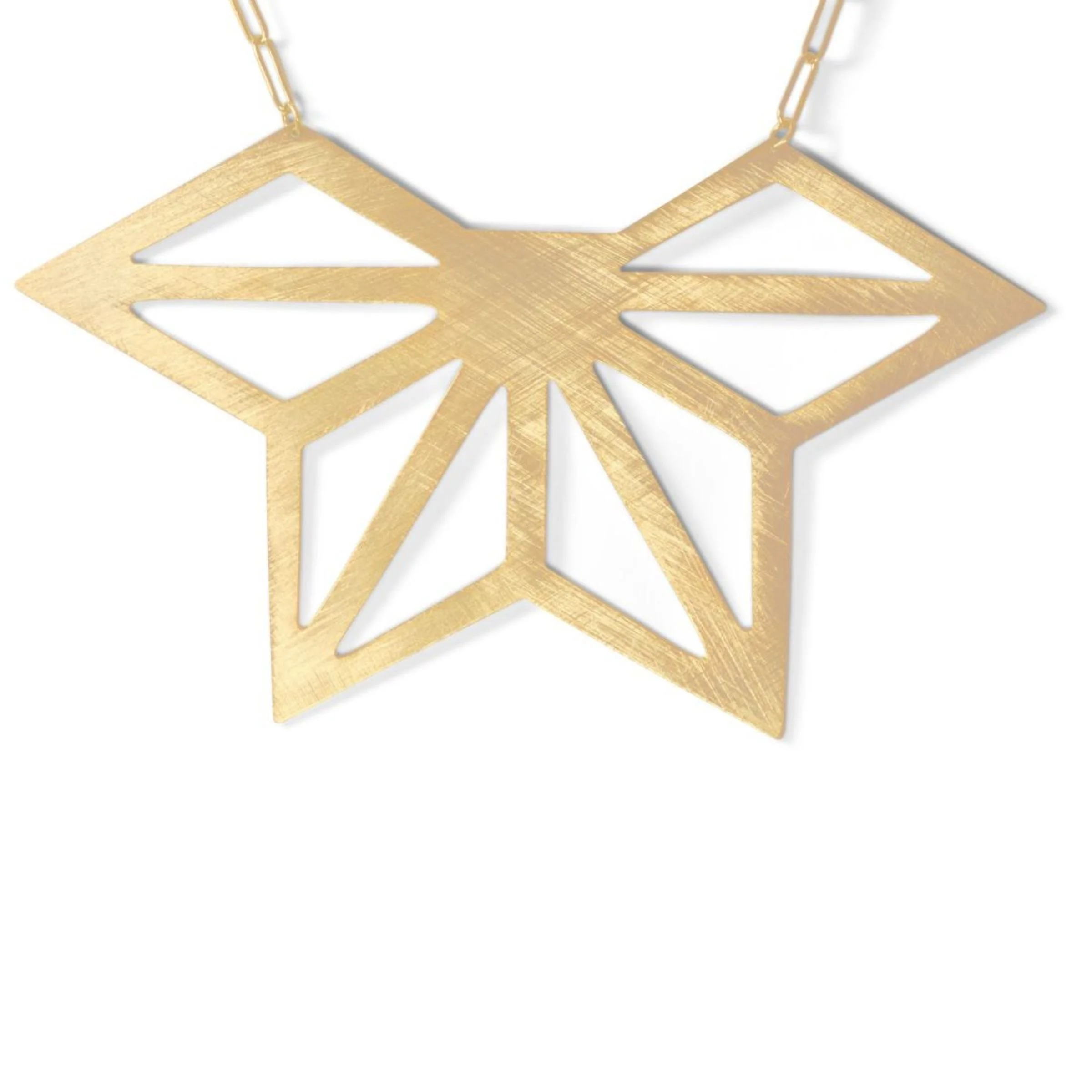 Close-up detail of the EatMetal Hemi-Asanoha pendant showing the hand-finished cross-hatched surface texture on 22k gold overlay brass.