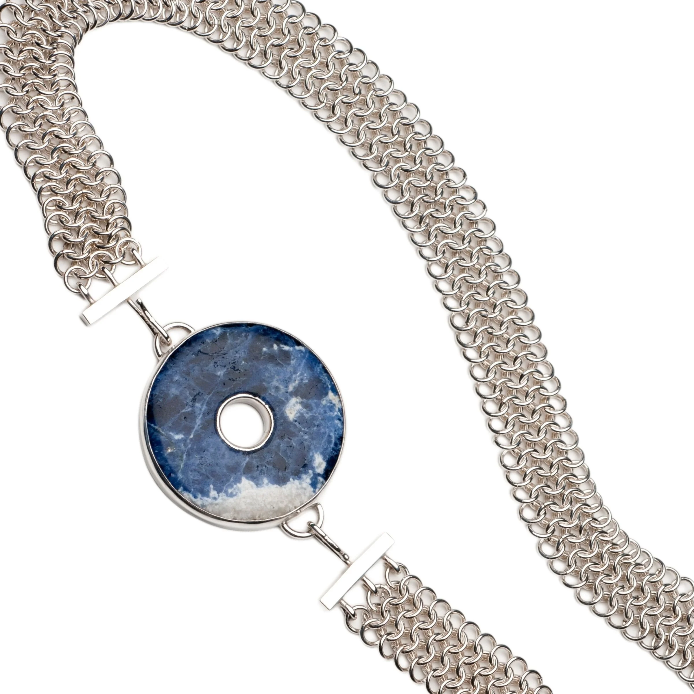 Bespoke Custom Jewelry Design -Artisan sterling silver chainmail collar necklace featuring a wide, multi-row woven chain and a removable central circular bezel-set blue sodalite gemstone donut pendant with natural white inclusions