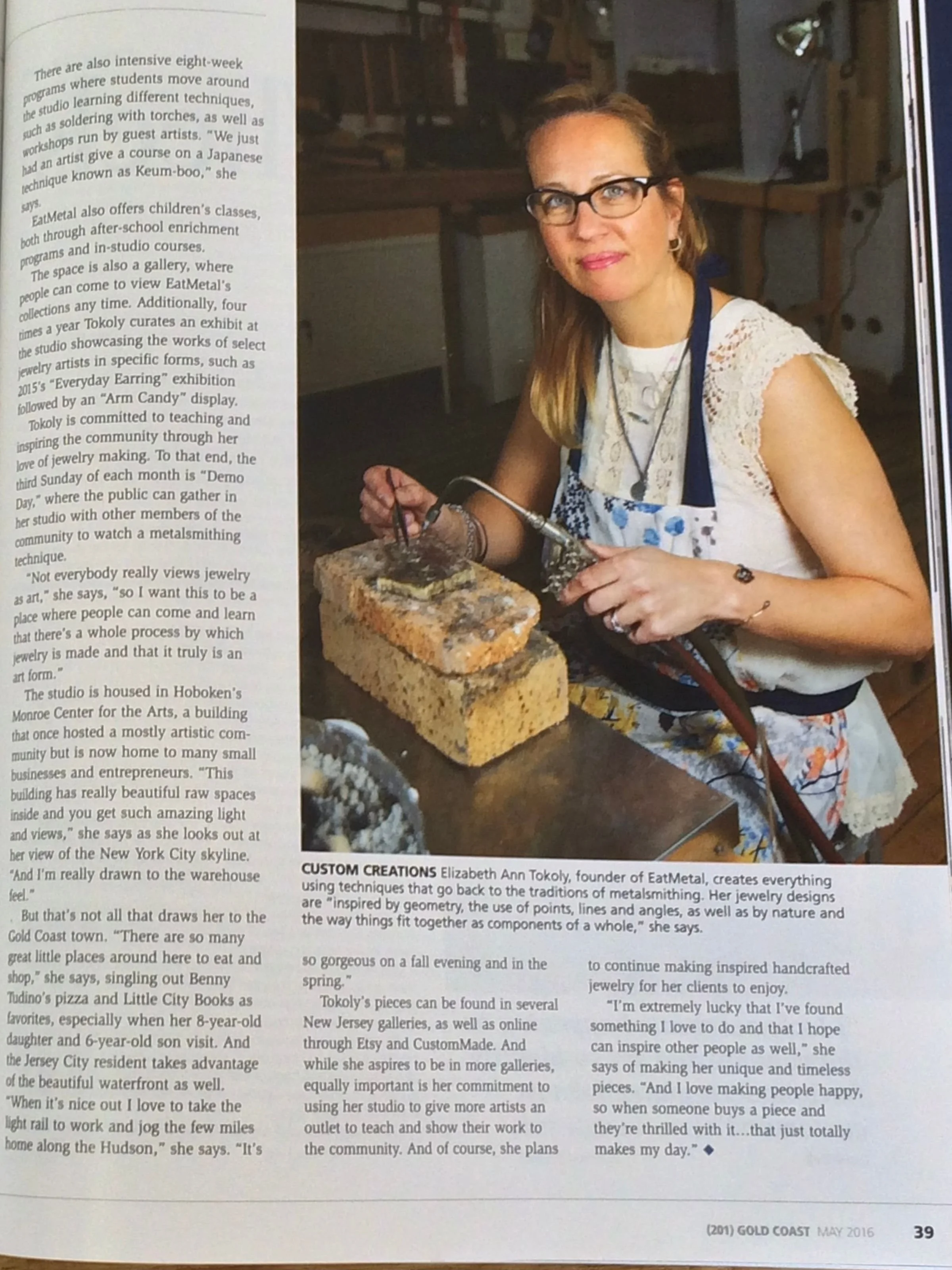 Elizabeth founder of eatmetal using the torch to make fine art jewelry, shown in gold coast magazine