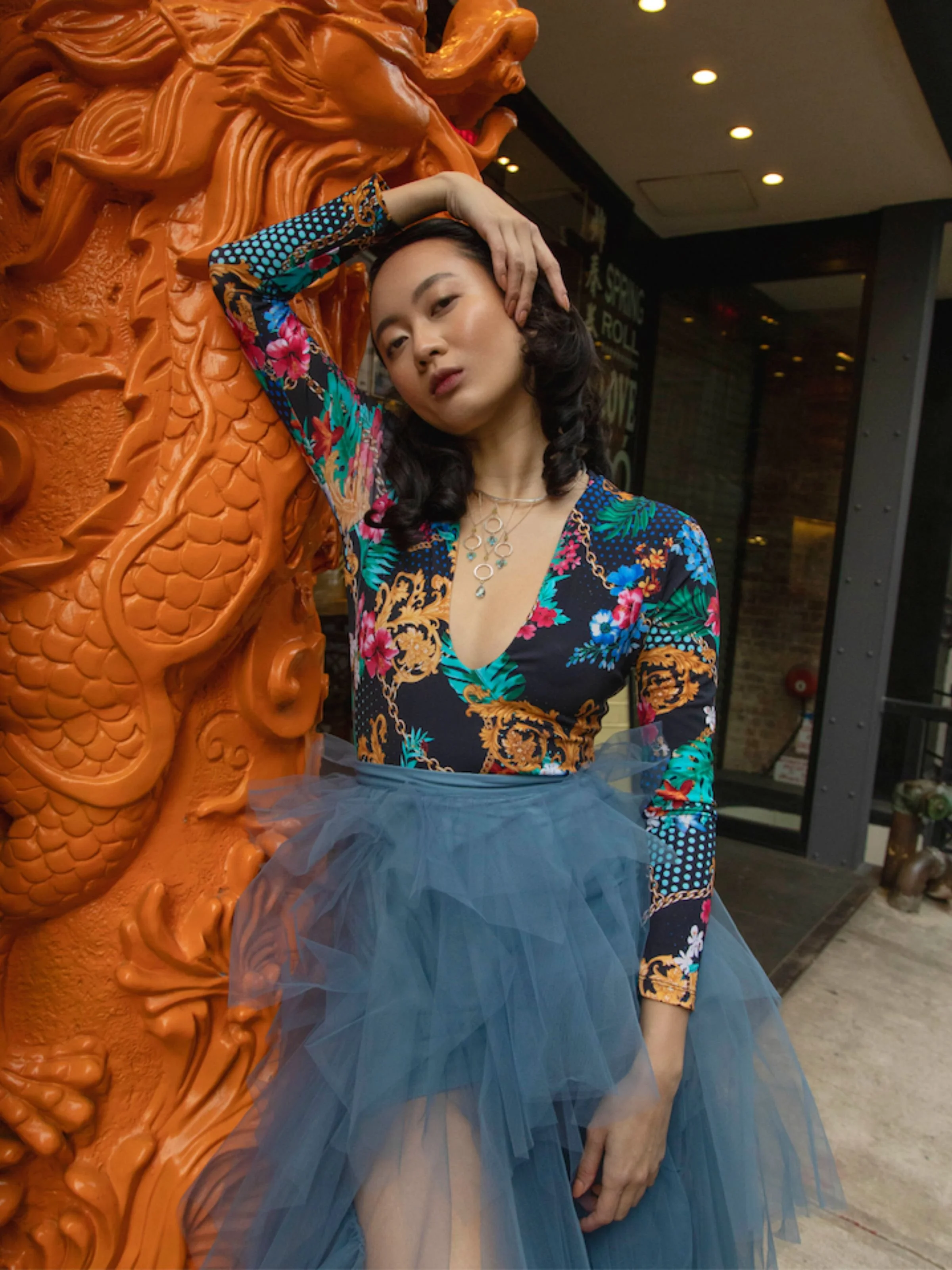 Gemstone Collar by eatmetal uses sterling silver peridot peruvian opals aquamarine topaz and signature mini circlet. Shown on fashion model with orange dragon pillar for Weekly Style Magazine