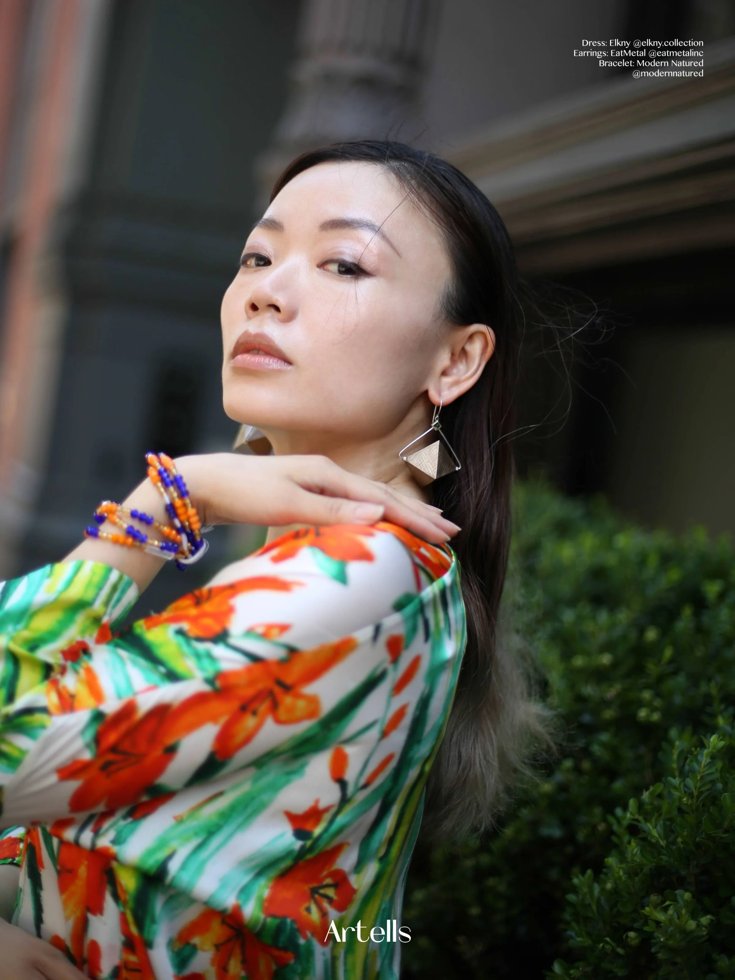 Artell's Magazine model wearing EatMetal fine art jewelry Octahedron Earrings sterling silver bronze and tourmaline