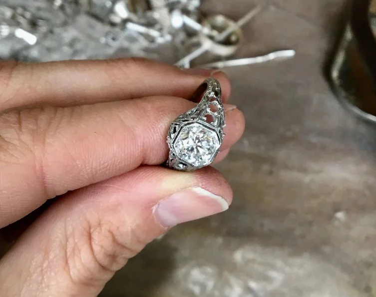 bespoke Platinum diamond ring is shown in hand to show step two, discussing the cost and process of making custom jewelry