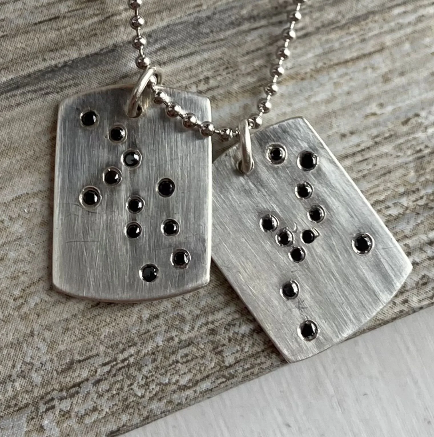 two black diamond set constellation zodiac star virgo and taurus dog tags in sterling silver designed by eatmetal
