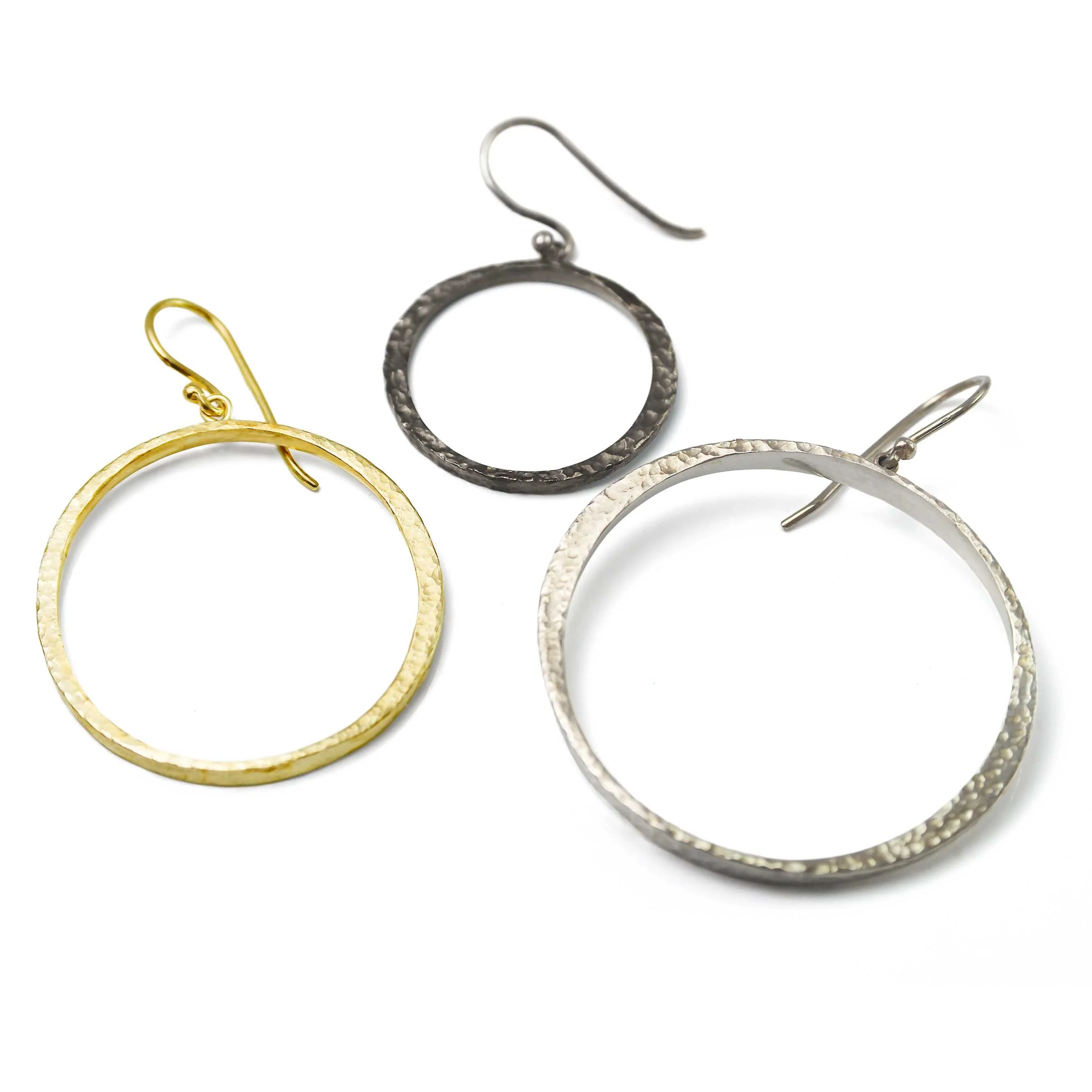 Comparison of gold, sterling silver, and black patina circle dangle earrings in classic, petite, and mini sizes