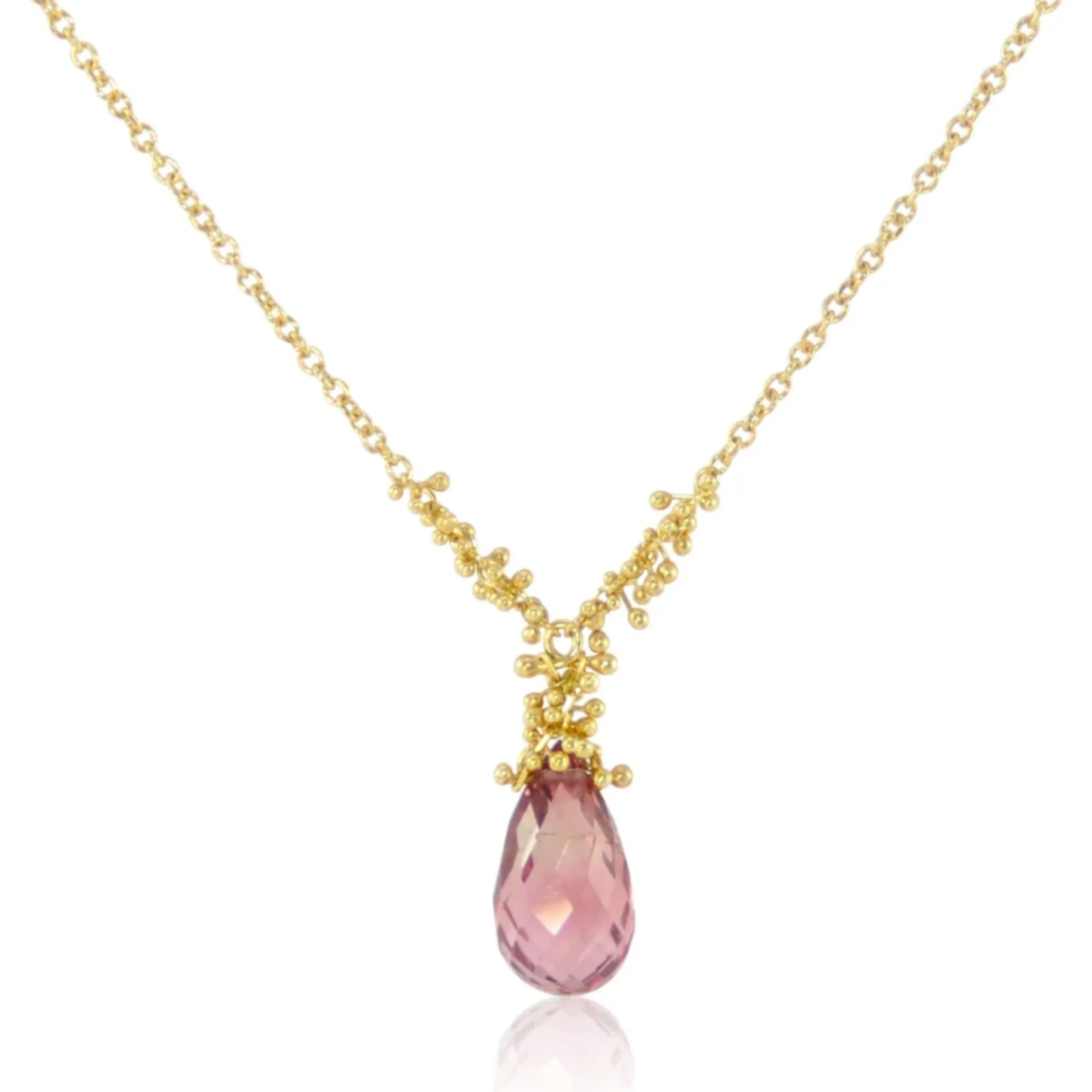 A modern 14k yellow gold chain necklace with 18k gold intricate beaded cluster bail supporting a pink tourmaline teardrop gemstone pendant