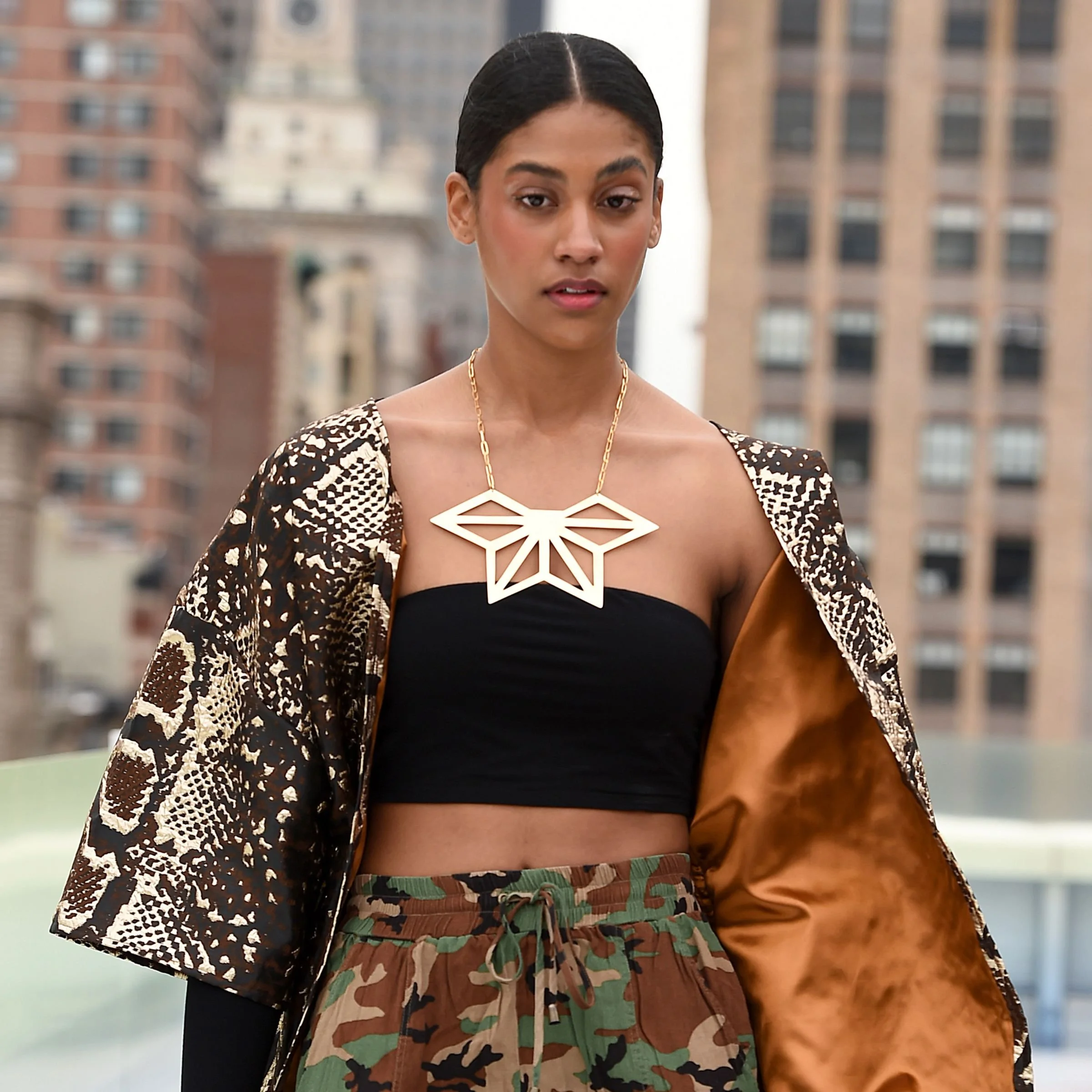 Editorial styled view of a model wearing the EatMetal Hemi-Asanoha 22k gold overlay brass geometric statement necklace.