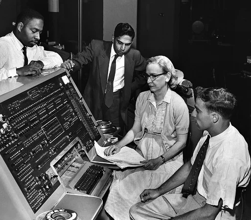 by Unknown (Smithsonian Institution) (Flickr: Grace Hopper and UNIVAC) [CC-BY-2.0], via Wikimedia Commons