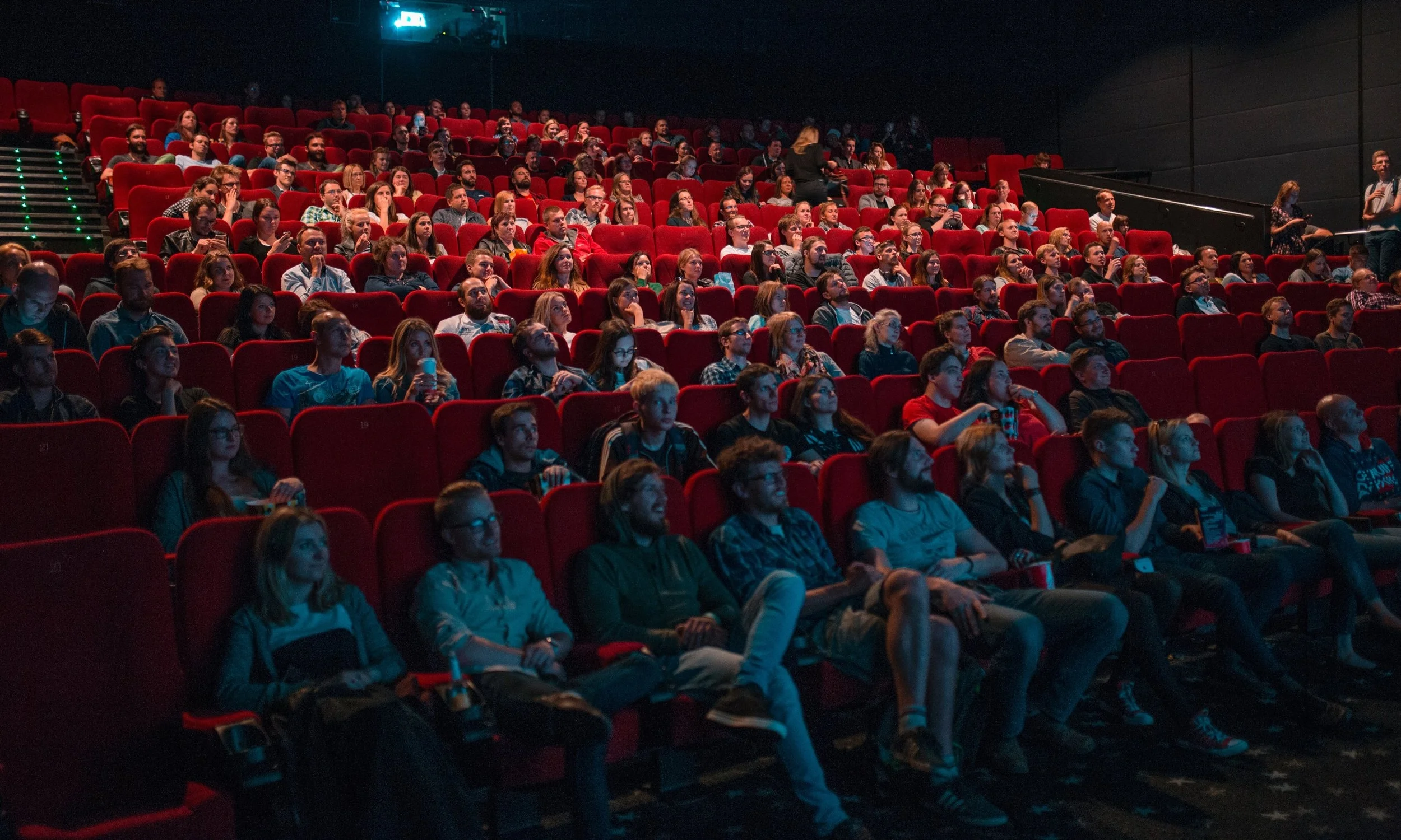 an audience in dark movie theatre