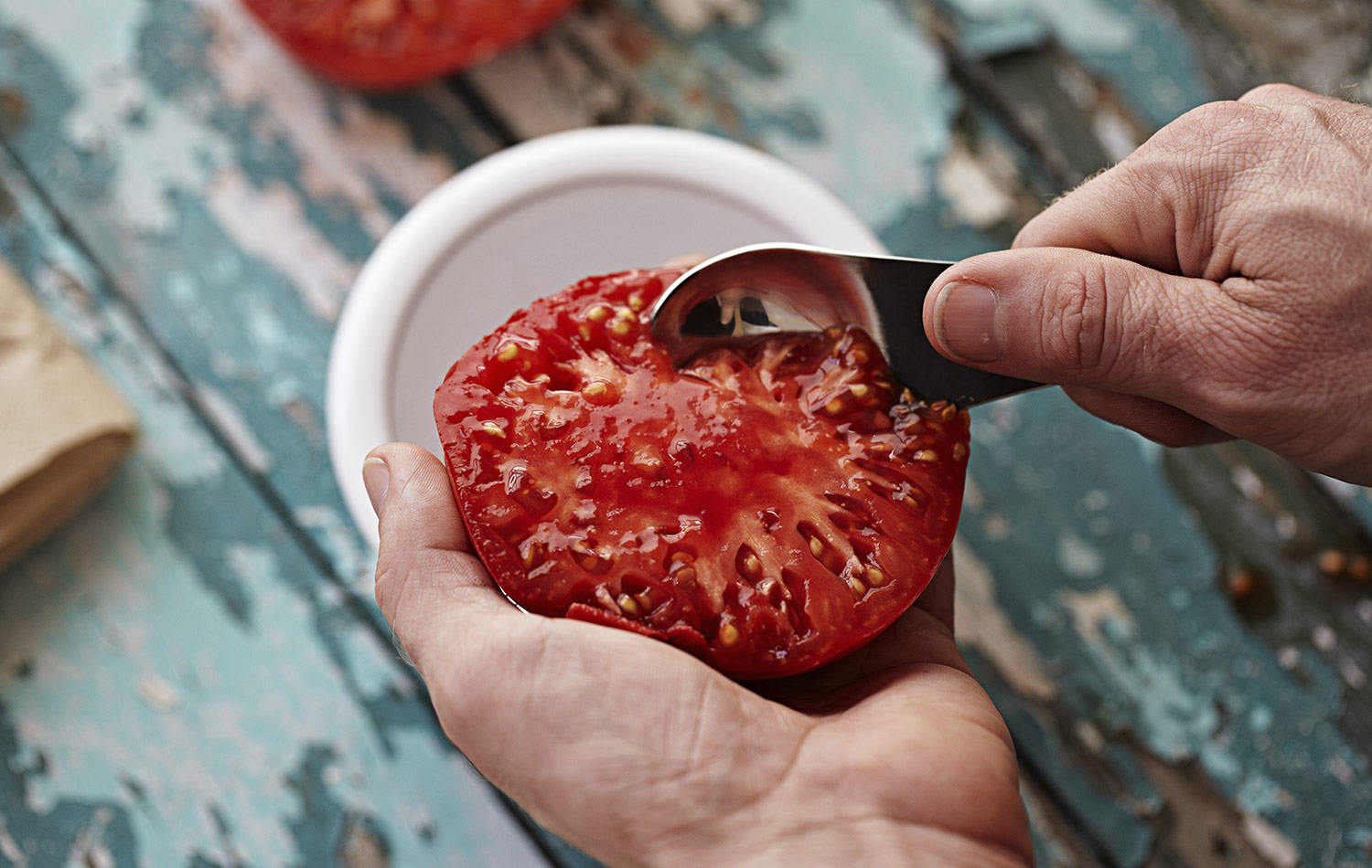 Start scooping out the pulp and seeds and discard the skin. Collect it in a container, bowl or jar. I scoop mine into a bowl then transfer over to a mason jar.