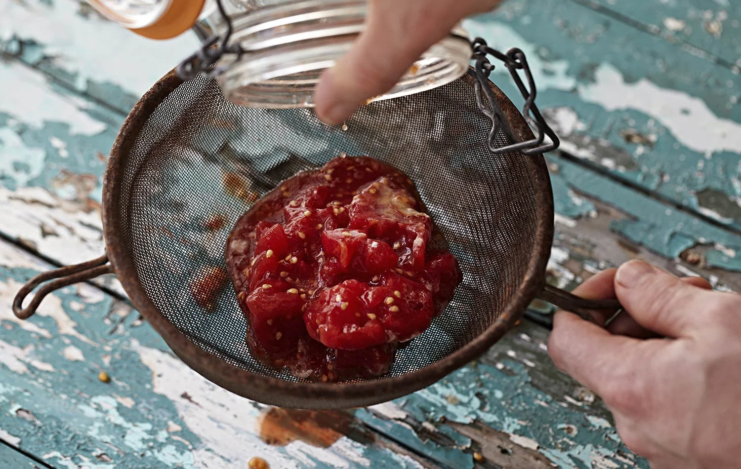 The pulp and seeds in the sieve ready to be separated. 