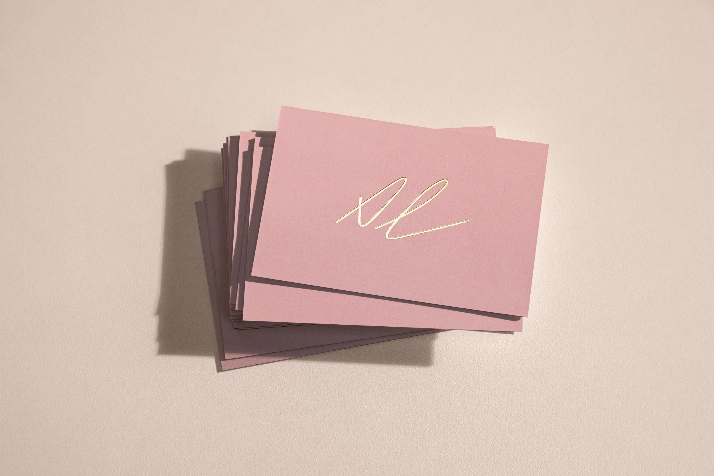 Roscher Creative branding design for Amber Lenette Stylist. Gold embossed logo on business card design.